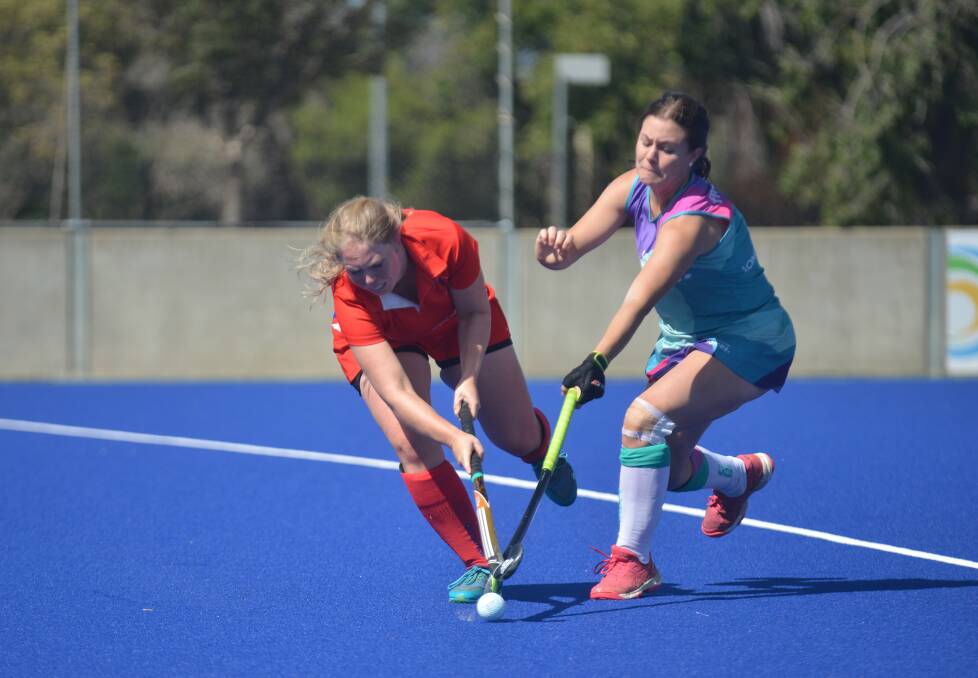 Tight tussle: South's Alice Bowler and Flames' Grace Collins compete for possession during their clash. 