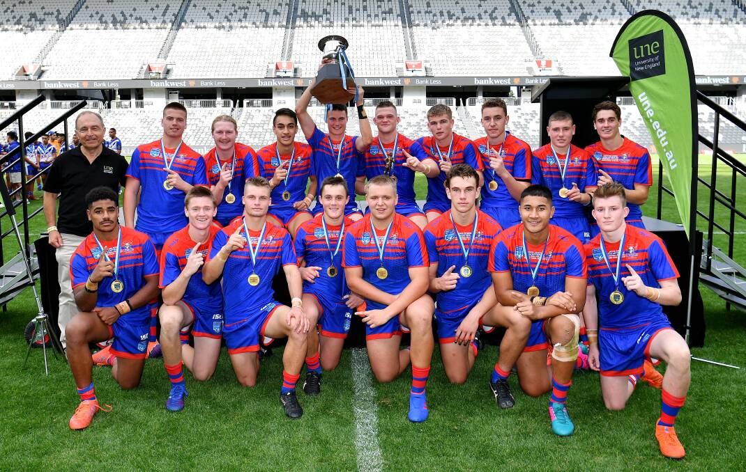 Mitch Henderson (fourth from left) with his victorious Newcastle Knights Matthews Cup side. Photos: NRL Photos