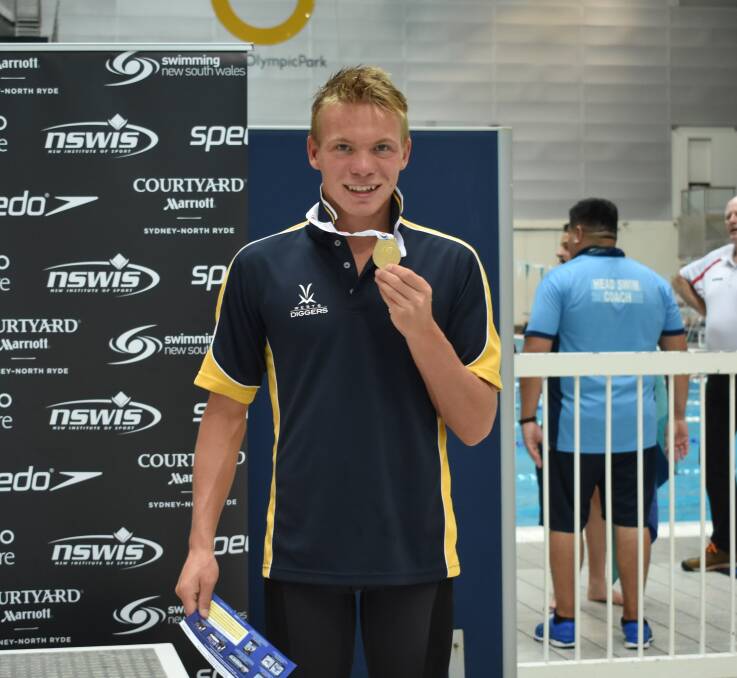 Golden swim: Connor Roberts shows off his gold medal from the 100m butterfly.