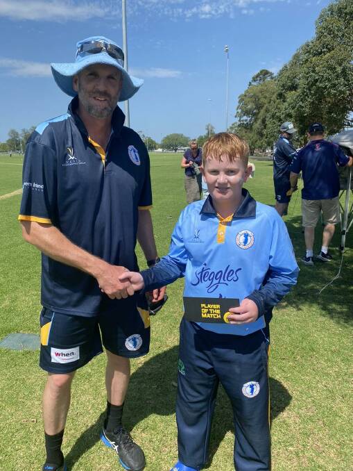 Wilson is presented with his player of the match award by his Tamworth Blue co-coach Nigel Parkinson. Picture Tamworth Junior Cricket Association Facebook