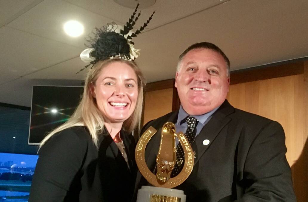 It's gold: Bianca and Andrew Pieper pose with the Golden Slipper following She Will Reign's stunning victory in the $3.5 million race at Rosehill on Saturday.