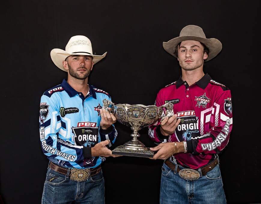 The rivalry resumes: Tamworth cowboy Lachlan Slade (NSW) and Queensland's Kelsey Pavlou with the trophy the states will be vying for in this year's PBR Australia Origin Series. Photo: Supplied