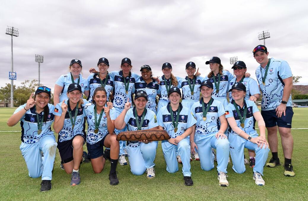Unbeatable: Lara Graham (back fifth from left) and Zoe Fleming (front second from right) and their NSW team-mates celebrate a 13th straight National Indigenous Championships title.