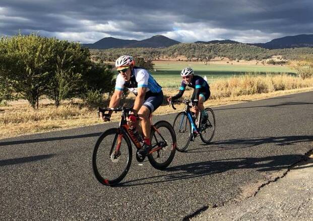 Hard work: Terry Balla has Amy Clift hot on his wheel during Saturday's local race at Moore Creek. Photo: Tamworth Cycle Club Facebook. 