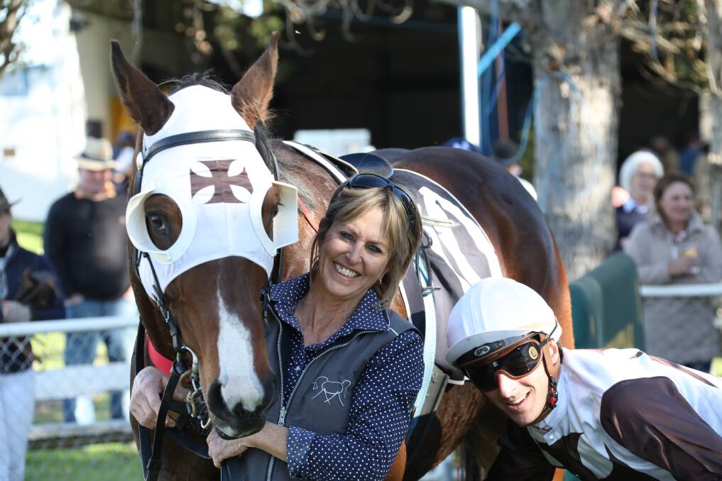 Terrific trio: Michelle Fleming is all smiles with jockey Alexandre Lemarie after St Luke's triumph in the Bold Karioi Picnic Cup at Gunnedah. Photo: Bradley Photos