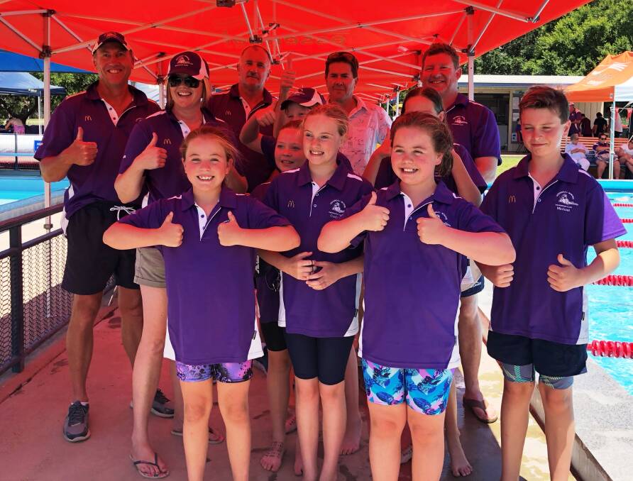Helping hand: Member for Tamworth Kevin Anderson (back) with members of the Kootingal-Moonbi Swimming Club at the club's annual carnival on Sunday. The club has received a $5000 grant. 