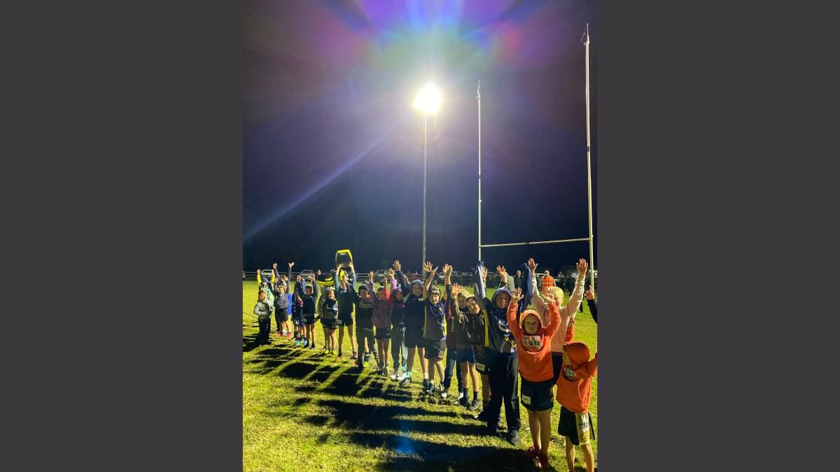 Shining bright: Some of Dungowan's junior players test out the new lights at the Dungowan Recreation Reserve.