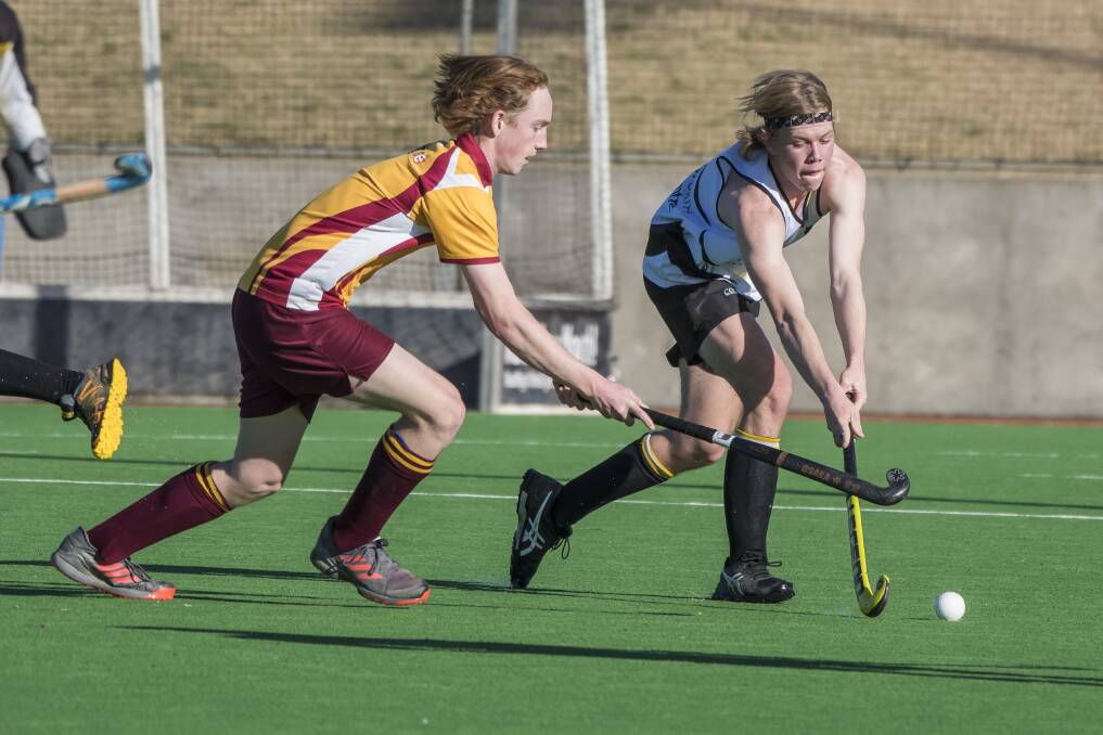 Tussle: Tudor Wests' Noah Pitt (left) and Workies' Calvin Farmilo were prominent for their respective sides in their 5-all draw on Sunday. Photo: Peter Hardin 