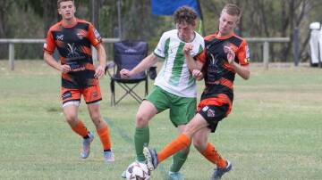 Moore Creek captain Hayden Davidson jostles with a Sawtell opponent during their Australia Cup clash on Sunday. Picture by Peter Hardin
