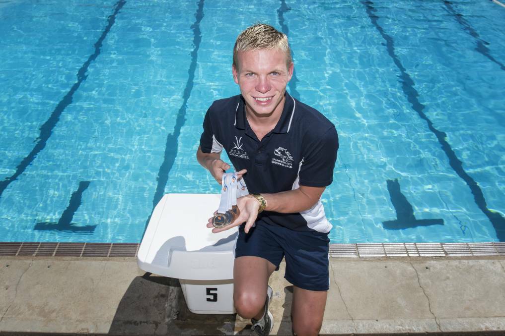 Connor Roberts with his haul from last year's State Championships. The Tamworth City swimmer is now a nationals medallist after winning bronze in the 17-years 200m breaststroke. Photo: Peter Hardin