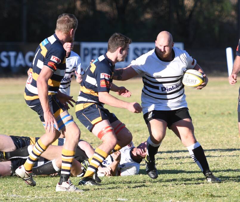 Power: Tamworth prop Matt White looks to give an Armidale defender the brush off. White has been a valuable addition to the Magpies' pack this season. Photo: Samantha Newsam