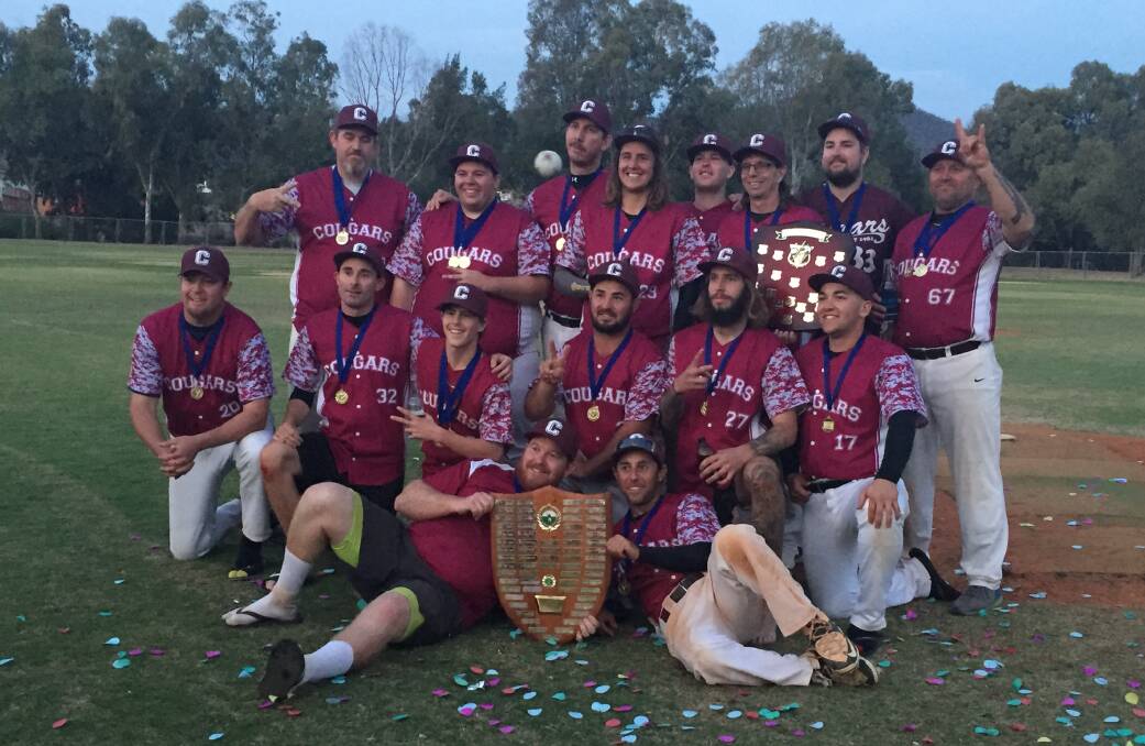 Two-in-a-row: Cougars celebrate after defending their Tamworth baseball A grade title.