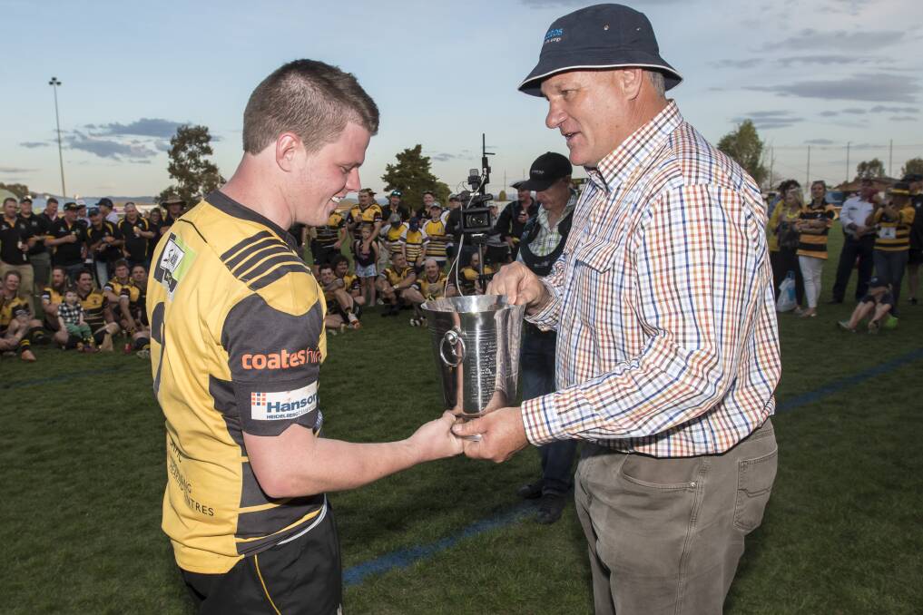 Tim Collins receives his player of the grand final trophy. Photo: Peter Hardin
