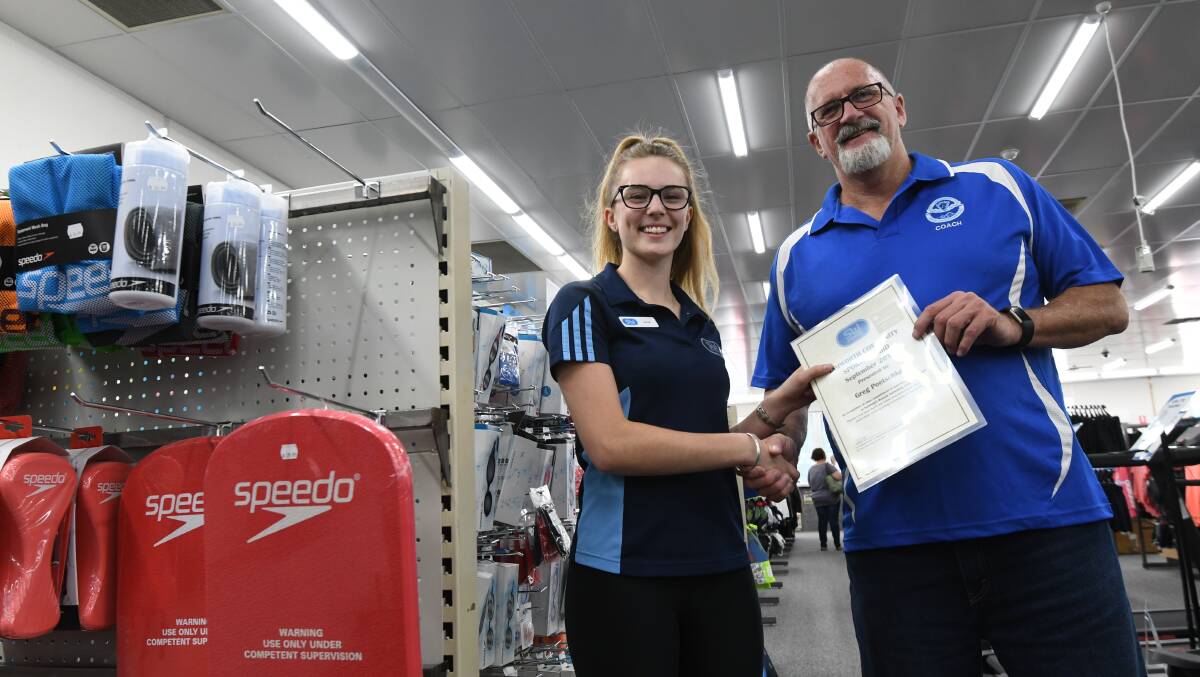 Recognition: Sportsmans Warehouse's Alix Sills presents Greg Poetschka with the Community Sports Award for April. Photo: Gareth Gardner