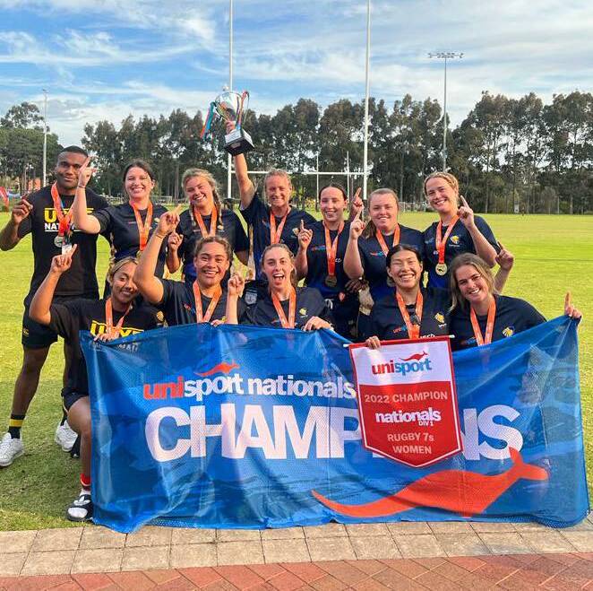 Claudia (holding the trophy) celebrates with her Sydney Uni team-mates. Picture Sydney University Football Club Facebook.