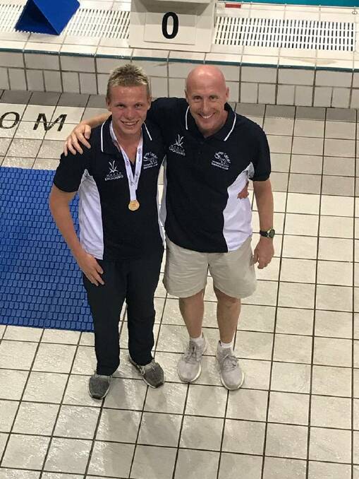 Champion effort: Connor Roberts (left) with his Tamworth City coach Nicholas Monet after winning gold in the 16 years 200m individual medley.