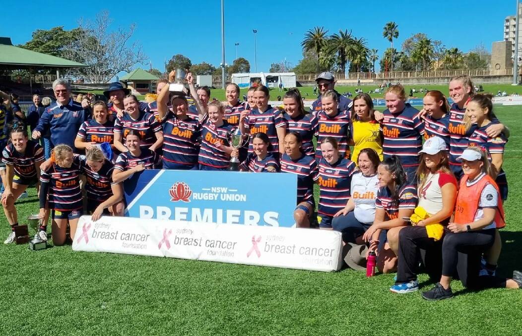 Brooke McKinnon (back sixth from right), Eliza O'Donnell (back fourth from right) and Martha Harvey (back third from right) with their Eastern Suburbs team-mates following their Jack Scott Cup triumph.