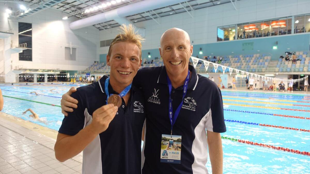 Fantastic achievement: Connor Roberts (left) with a very proud coach Nicholas Monet after winning bronze in the 17-years boys 200m individual medley at the Australian Age Championships.