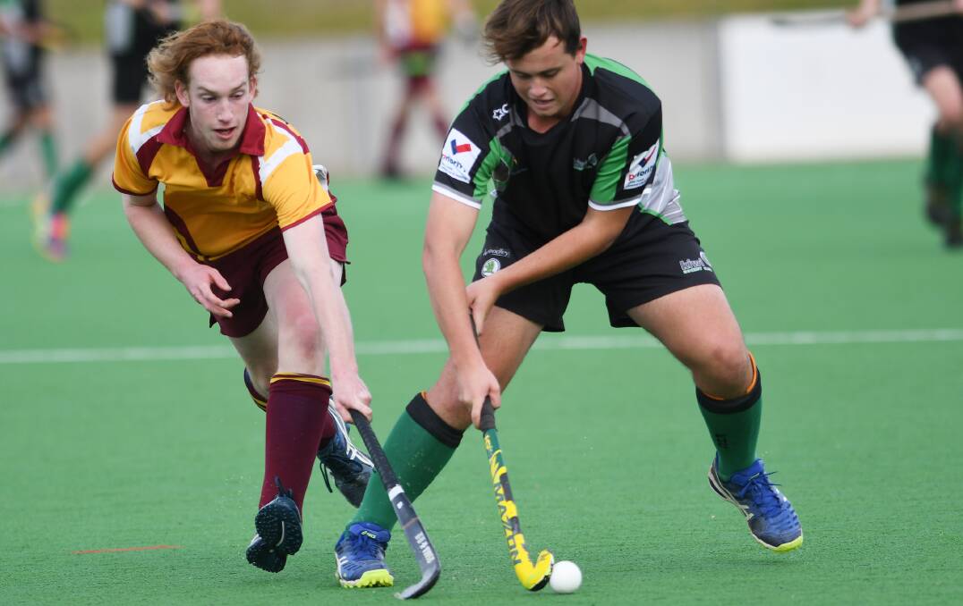 Challenge: Kiwis' Oscar Spinks (right) fends off the attentions of Tudors' Noah Pitt during their clash on Sunday. Kiwis prevailed 3-1 to post their second win of the season. Photo: Gareth Gardner