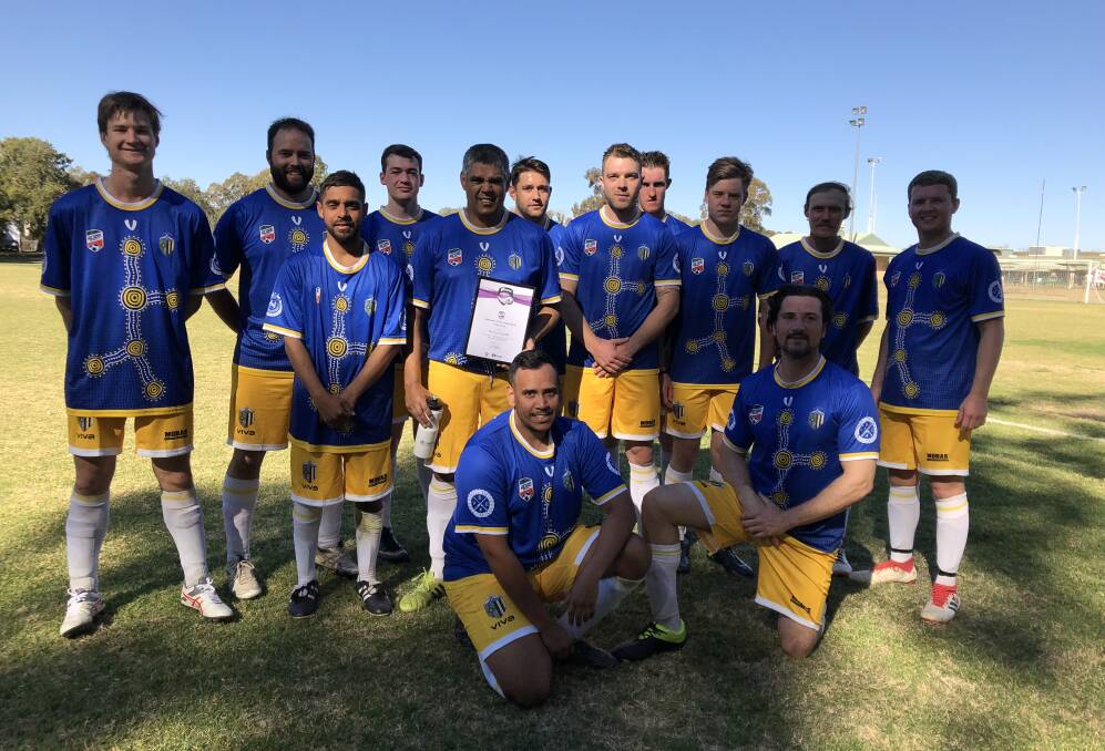 Darrel Smith (centre) with his Community Coach of the Month award and his Moree Services FC team-mates. Photo: Supplied