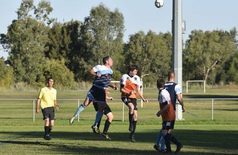 High ball: Troy Hearfield goes for this header during their win over North Companions on Saturday. Photo: Billy Jupp