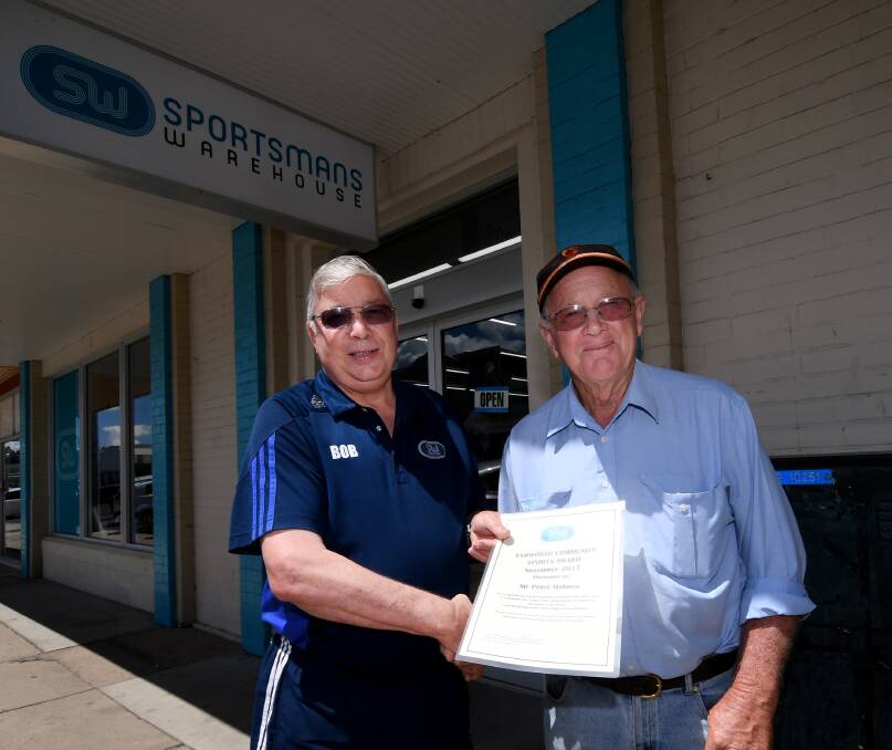Great work: Sportsmans Warehouse's Bob Barber congratulates Peter Holmes on winning the November Community Sport Award. Photo: Gareth Gardner 