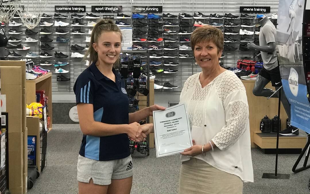 Honoured: Gail Salter (right) receives the Sportmans Warehouse Community Sports Award for November from Alix Sills. Photo: Suppllied