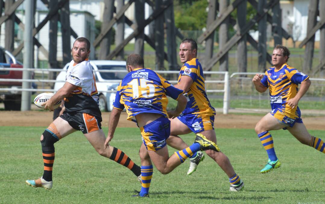 Breakaway: Manilla's Anthony Wicks looks for support as three Bundarra players give chase during their clash on Sunday.