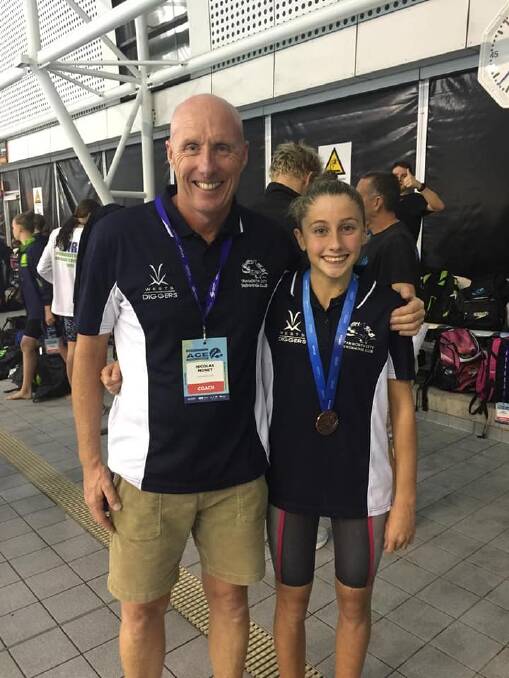 Alex Hayes (right) with coach Nicholas Monet after winning bronze in the 200m breaststroke at the Australian Age Championships. Photo: Tamworth City Swimming Club Facebook.