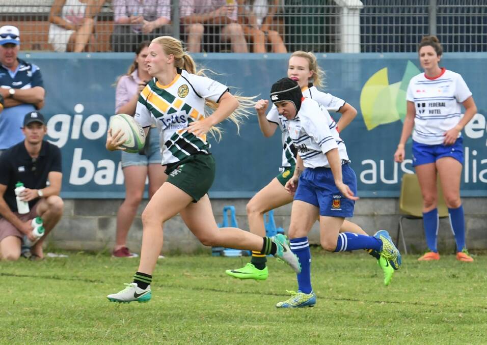Runaway: Lauren Nott streaks away for a try during last month's Armidale Knockout.