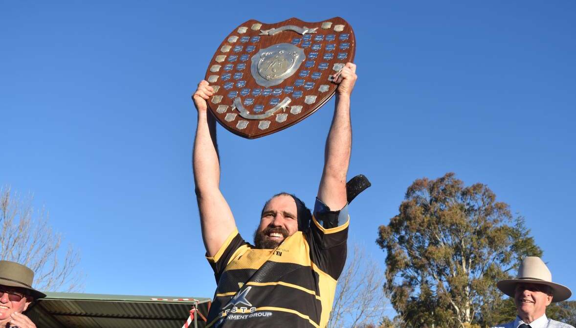 Up in the air: Pirates skipper Conrad Starr holds aloft the Heath Shield. Whether or not a champion will be crowned this year is uncertain at this stage. Photo: Ben Jaffrey
