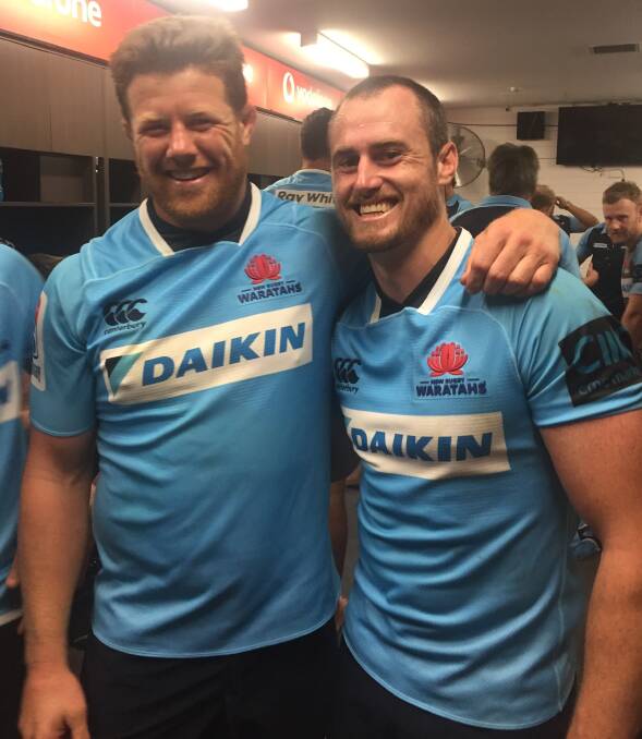 Blooming: Former Pirates team-mates Paddy Ryan and Mick Snowden celebrate Snowden's Waratahs debut and a bonus point win over the Melbourne Rebels on Sunday.  