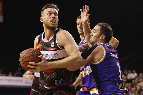 Nick Kay takes on Brisbane's Adam Gibson during their clash at WIN Entertainment Centre on Friday night. Photo: Mark Kolbe/Getty Images