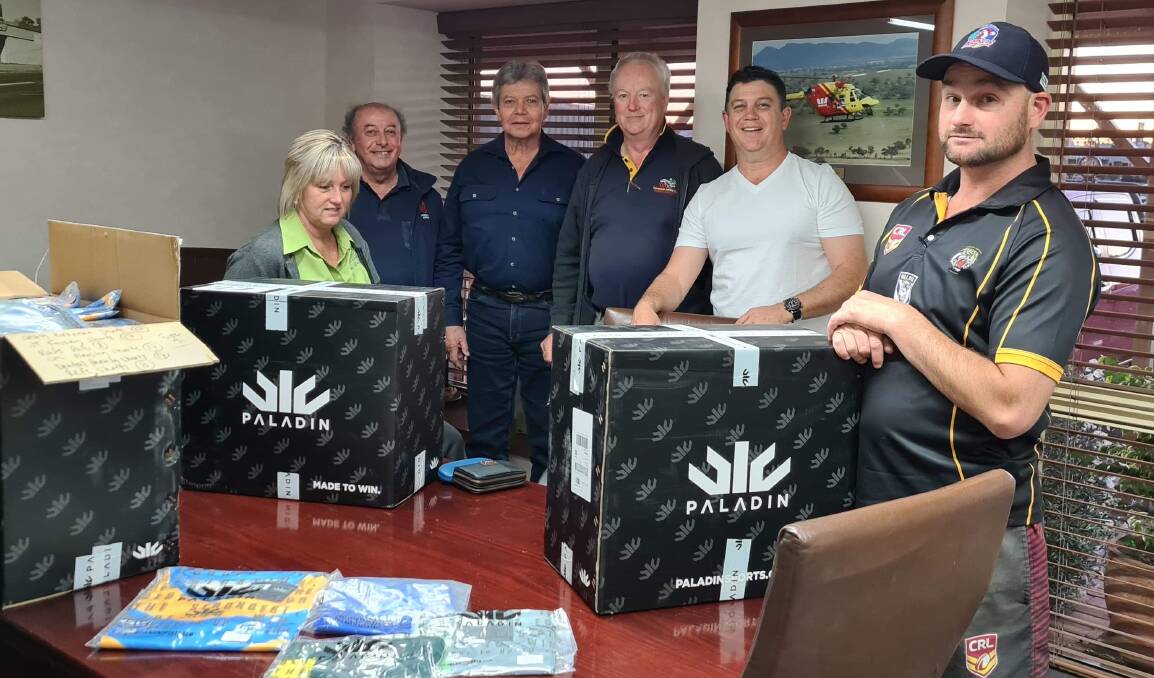 Ready for kick-off: Group 4 board members (from left) Lisa Dellar, Terry Psarakis, Ron Binge, Geoff Newling, Craig Power and Lad Jones inspect the Paladin rugby league gear ready for Saturday's opening round of the WEG 9s.
