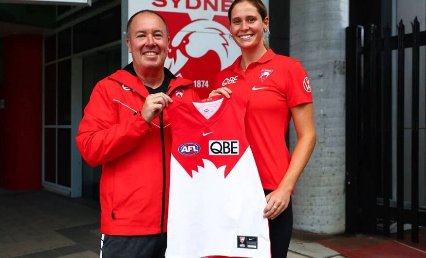 Beaming: Alice Mitchell receives her Sydney Swans jumper from AFLW senior coach Scott Gowans. Photo: Sydney Swans 