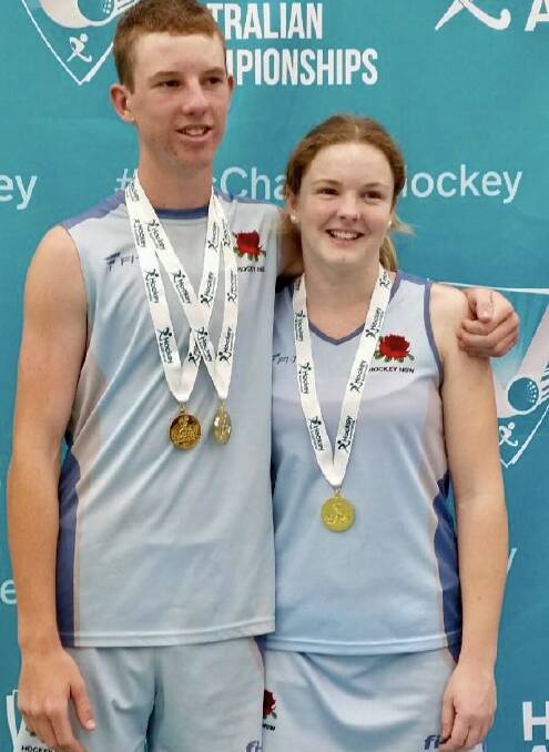 Ehren Hazell and Emily Chaffey with the spoils of their NSW side's triumphs. 