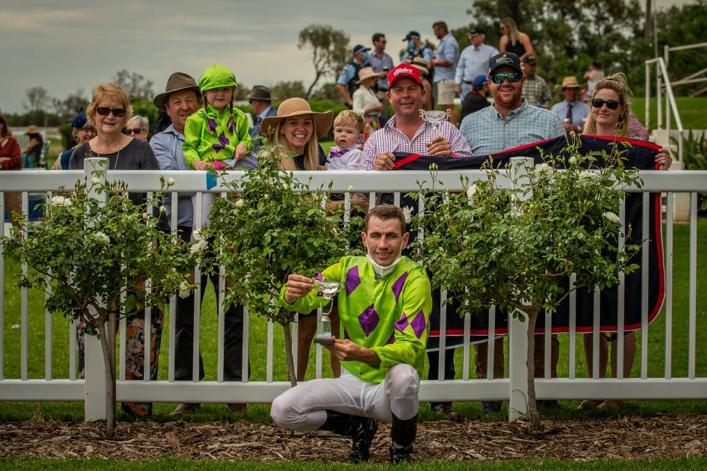 A win to savour: Evans holds the NSWPRA Picnic Champion Series trophy with connections of the Brett Robb trained, On A Promise, and members of the NSWPRA. Photo: Racing Photography.
