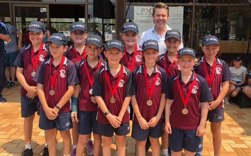 Acing the competition: The St Xaviers team pose with tournament namesake, and tennis legend, Todd Woodbridge, and their silver medals, after finishing second in the state-wide competition.