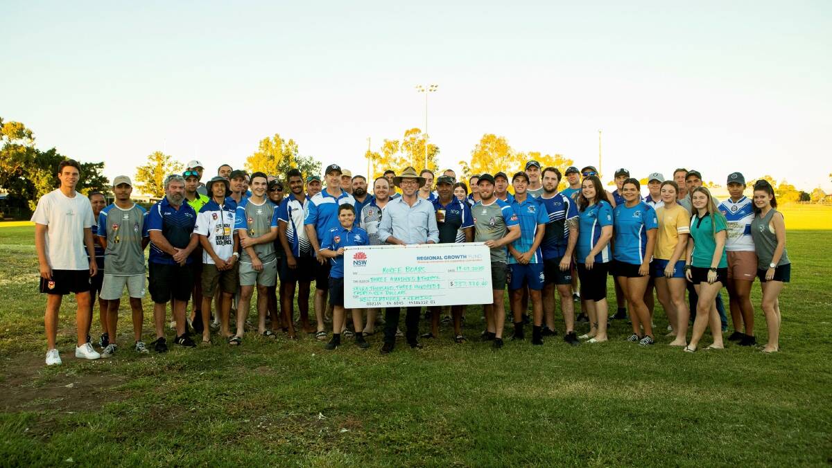 Northern tablelands MP Adam Marshall, centre, presents a large funding cheque to the Moree Boars Rugby League Football Club for a new clubhouse and grandstand.