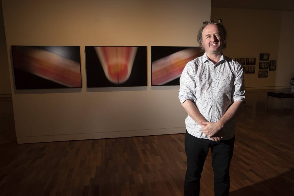 ART ATTACK: Artist Vic McEwan in front of some of his photographs in his 'Haunting' body of work. Photo: Peter Hardin