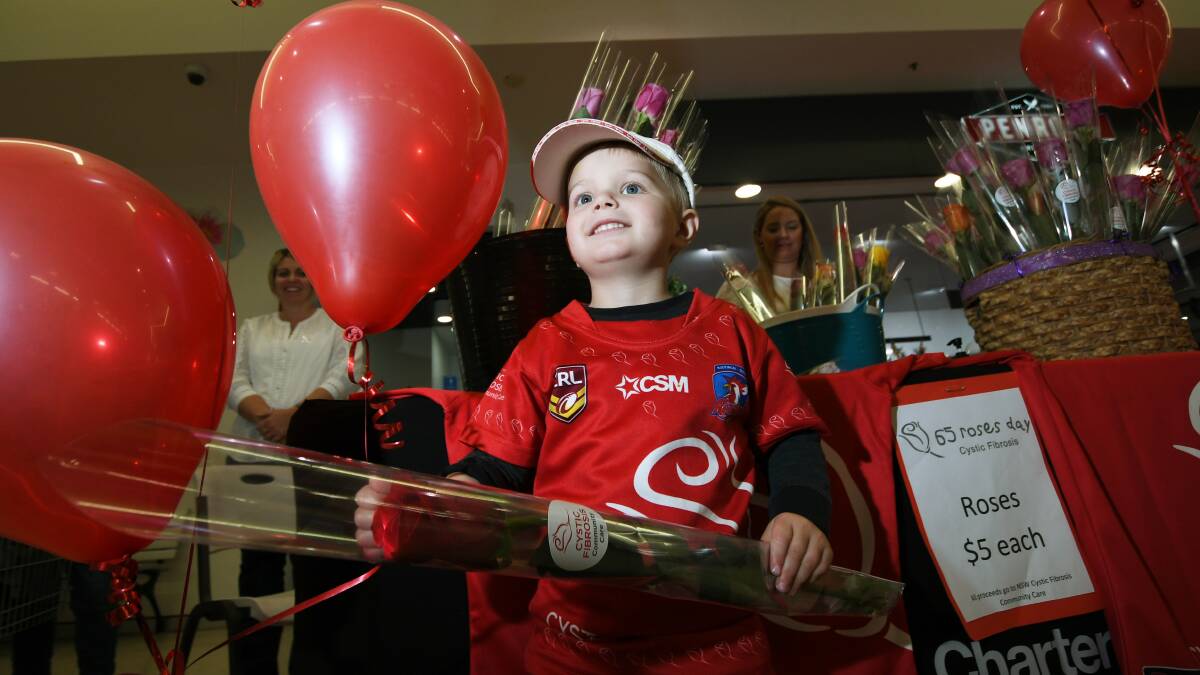 GOING RED: Three-year-old Jesse Jones has cystic fibrosis. He was there on the day helping his mum sell roses to locals. Photo: Gareth Gardner