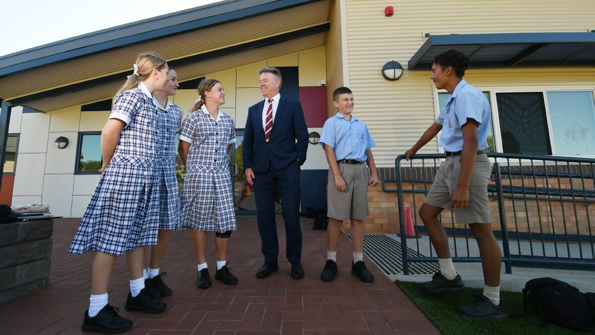 BUILDING BOOM: Calrossy Anglican School principal David Smith with Calrossy students out the front of the first new building. Photo: Gareth Gardner