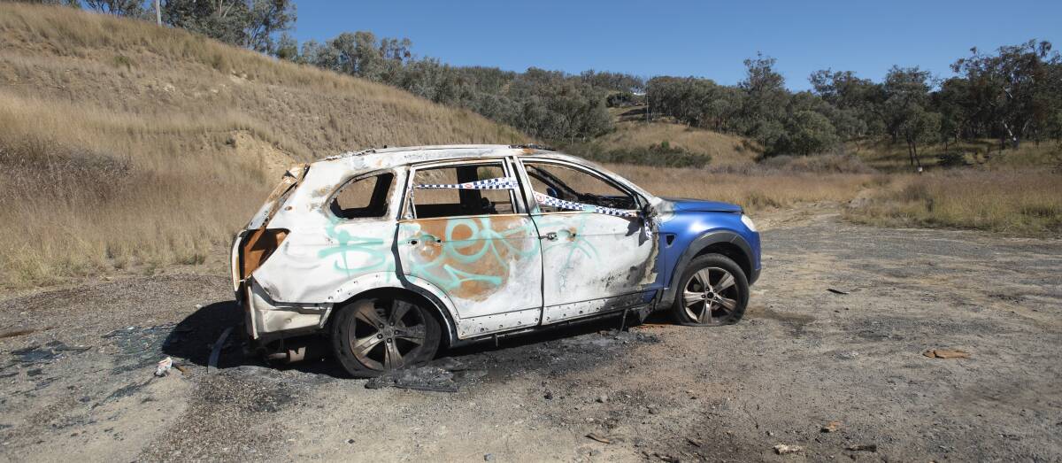 A torched car on Daruka Road on Monday. Photo: Peter Hardin