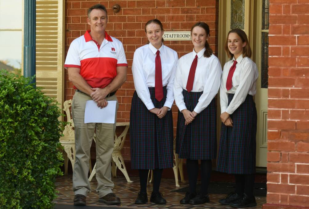 OPPORTUNITIES GALORE: Calrossy Anglican School careers advisor Charles Impey with year 11 students Grace Sweeney, Olivia Bowman, and Tahlia Barwick. Photo: Gareth Gardner