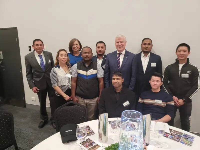 NO PERMANENT HOME: Multicultural Tamworth's Eddie Whitham (far left) with a group of the refugees wanting permanent visas, with Deputy Prime Minister Michael McCormack. Photo: supplied