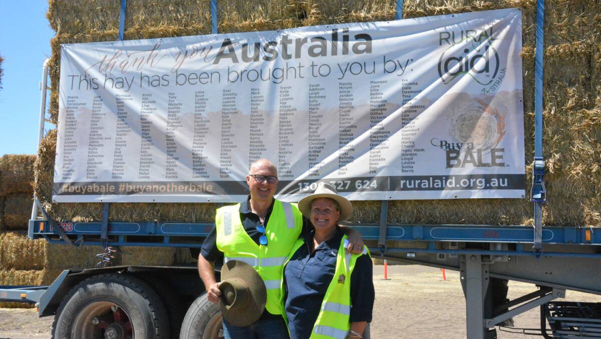 THANK YOU: Rural Aid's Craig Marsh and Tracy Alder stand in front of a roadtrain full of donated hay. Photo: Jessica Worboys