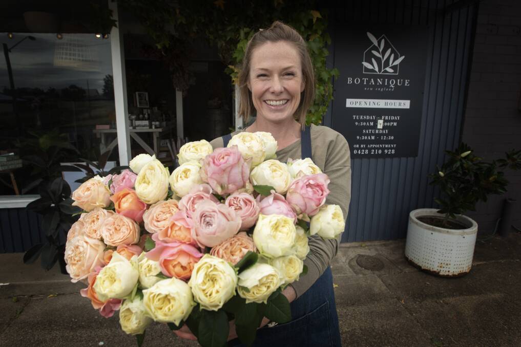 BEAUTIFUL BUNCH: Botanique New England owner Drue Daly with a big bunch of blooms. Pretty pinks are the top choice this year, she said. Photo: Peter Hardin