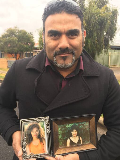John Hausia holding precious photos of sister Amelia, who went missing almost 25 years ago. Photo contributed.