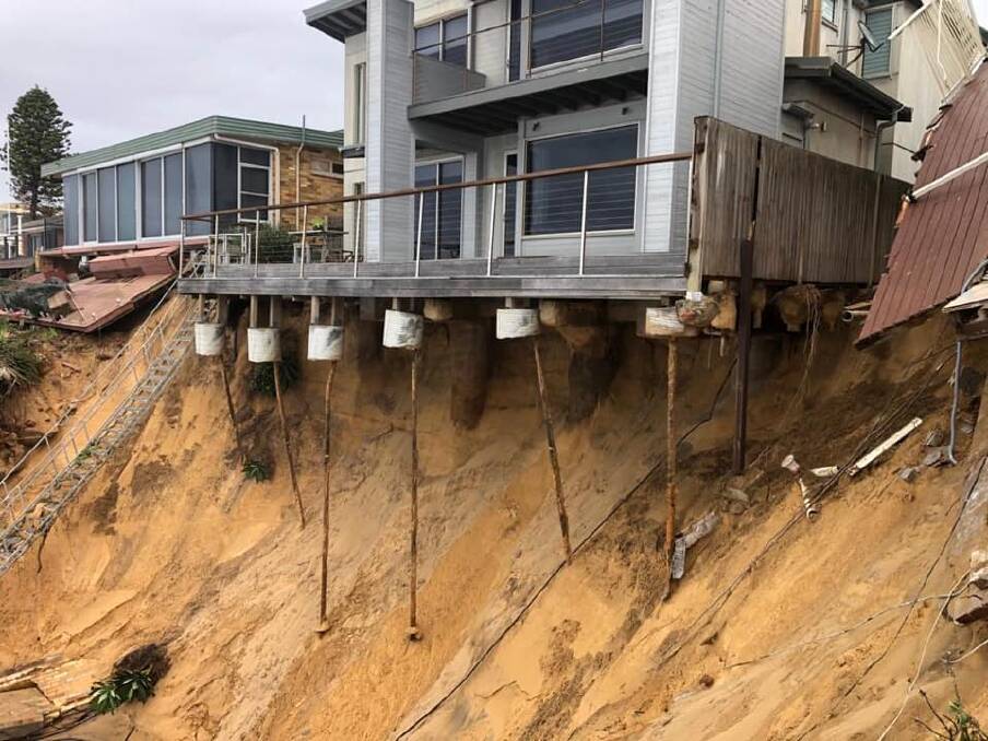 DAMAGE: A beachfront house in Wamberal on Sunday. Multiple homes were at risk, with at least two partially collapsing. Pictures: Facebook