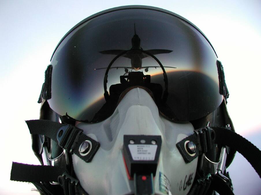 A fighter pilot captured a unique view in the reflection of his mask as he approaches to refuel. Photo: PAT McMAHON.